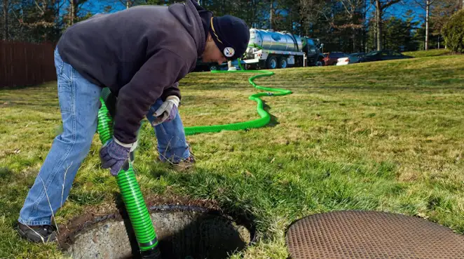 Service technician performing residential septic pumping and drainage maintenance in Las Vegas, NV